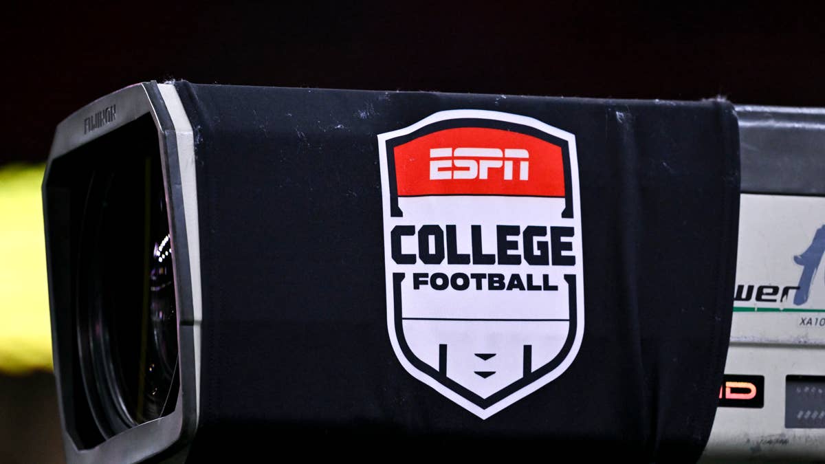 Close-up of a TV camera with an ESPN College Football logo sticker.