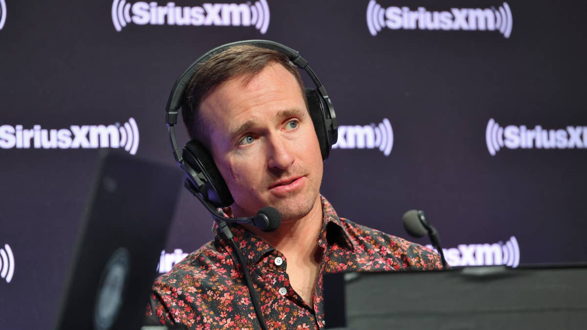 Drew Brees wearing a floral shirt and headphones in front of a SiriusXM backdrop.