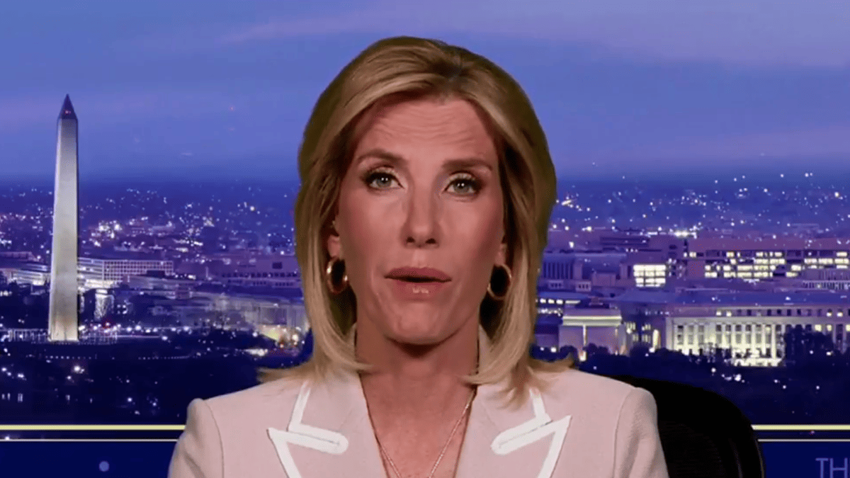 Laura Ingraham in a light pink blazer speaks with the Washington Monument and city skyline behind her.