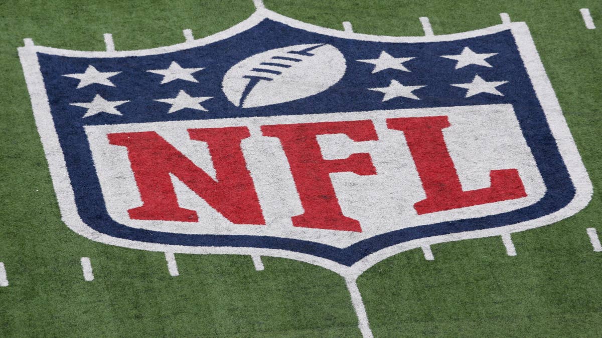 NFL logo on a football field with yard lines