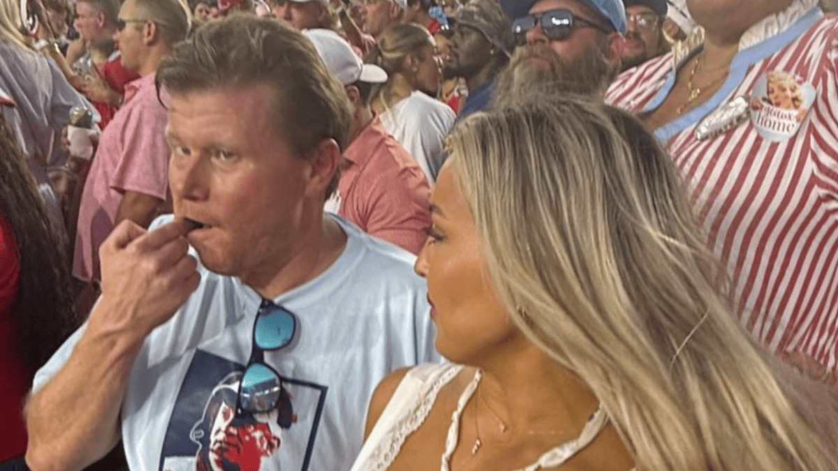 Hannah Minch and Ben Mintz in light blue Ole Miss t-shirts at a game.