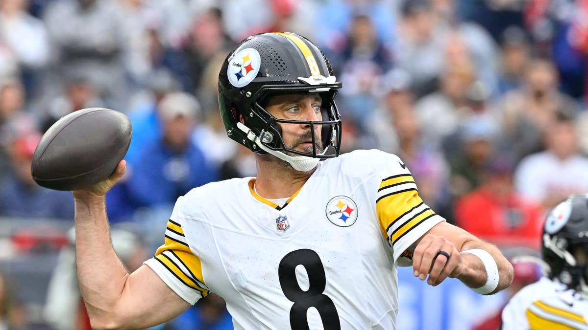 Steelers quarterback number 8 throws a football in a white and yellow jersey.