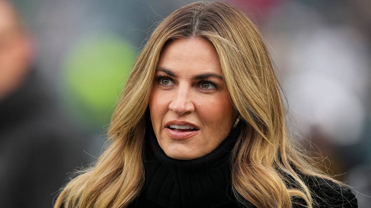 Erin Andrews in a black turtleneck at an outdoor event.