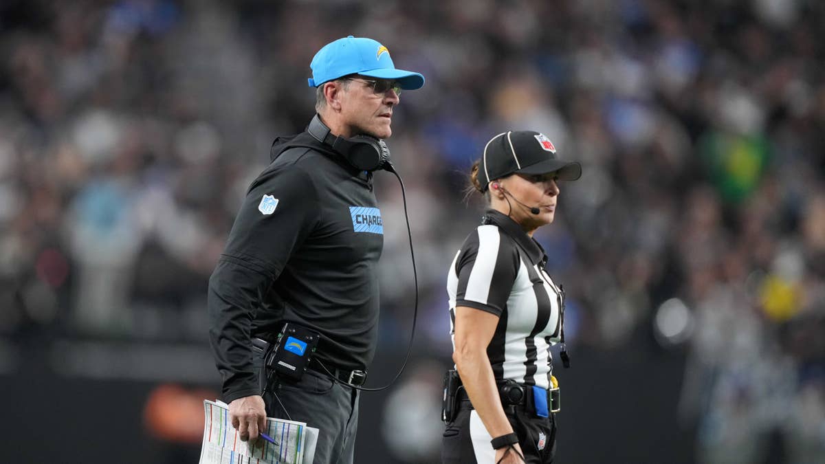 NFL coach with Chargers logo and referee on field